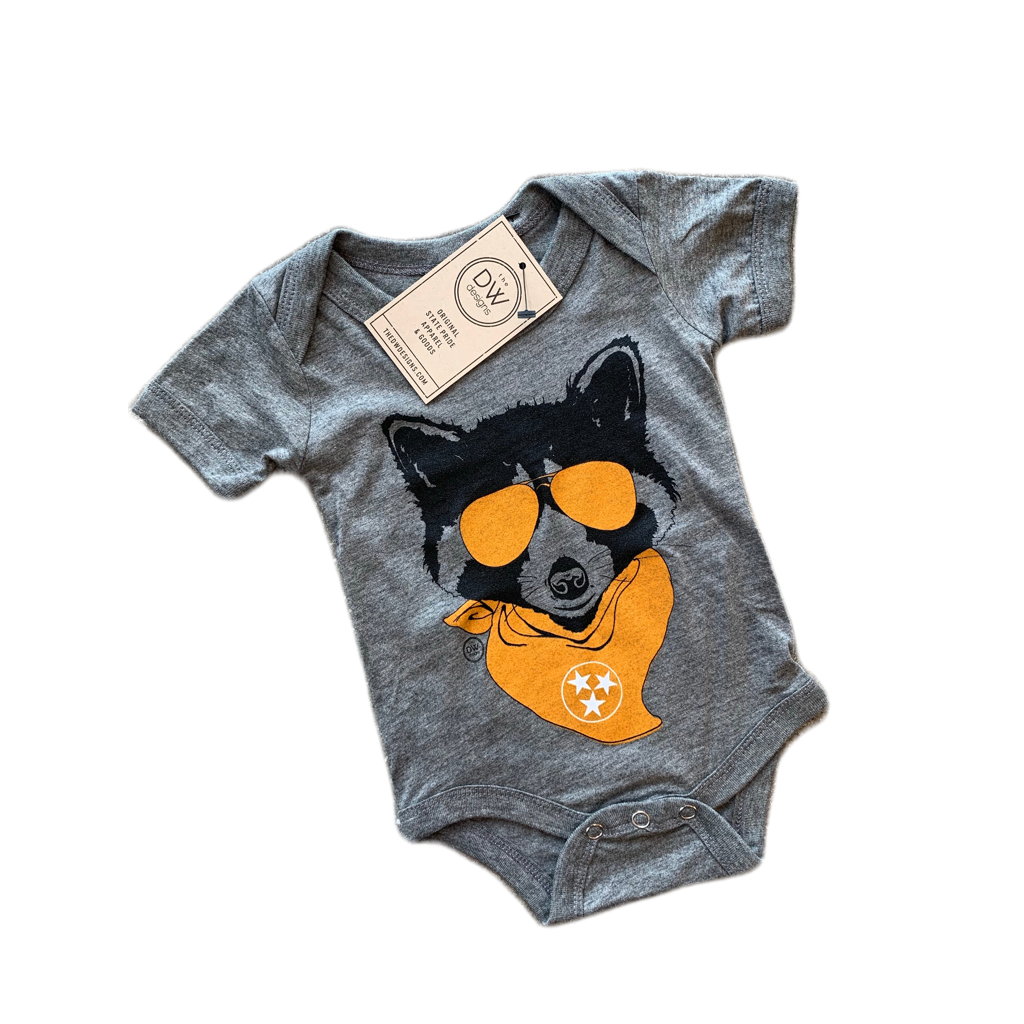 The Lil' Rascal Onesie features a dog wearing sunglasses and a tristar bandana. Sold by The DW Designs, Knoxville, TN.